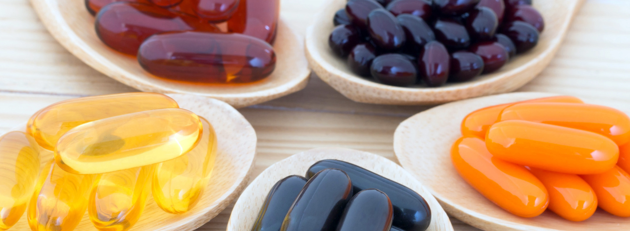 Healthy Vitamin supplement capsules in a spoons.